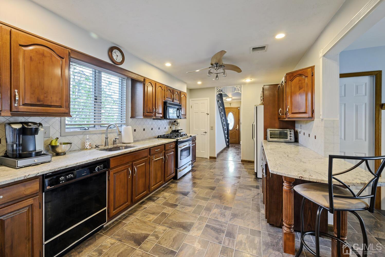 28 Rector Avenue Woodbridge, NJ 07095 - Photo 10 of 32 a large kitchen with stainless steel appliances granite countertop a stove and a sink