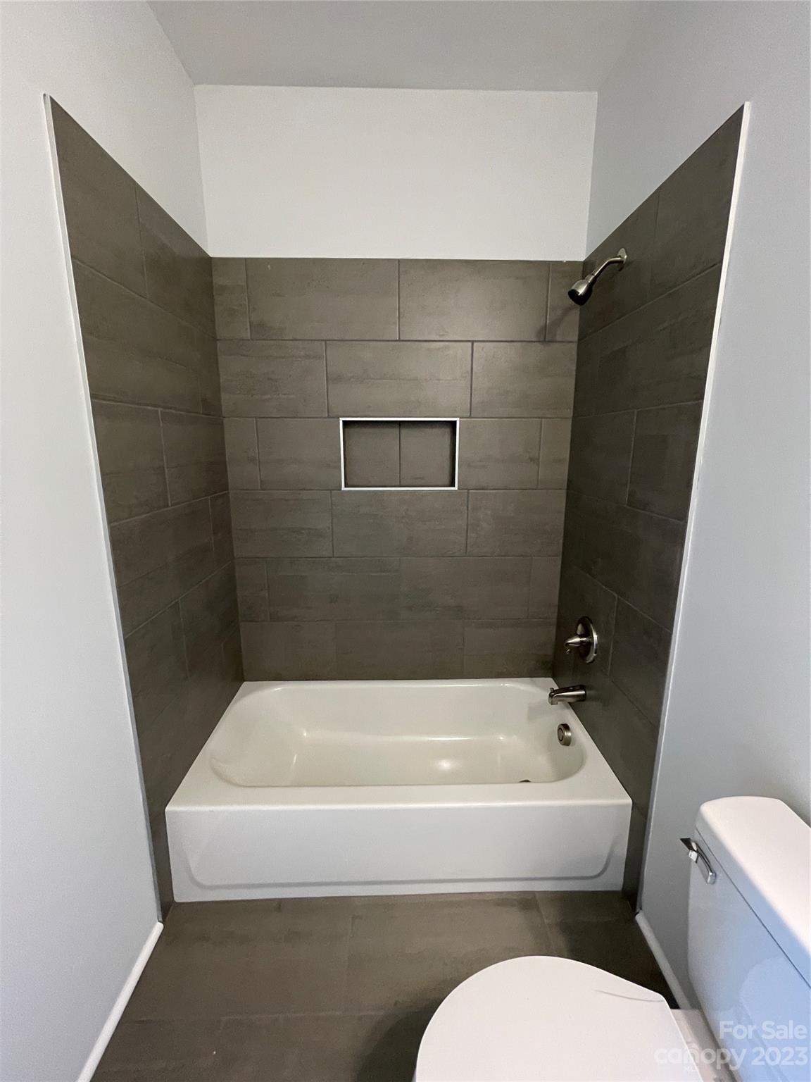 517 Correll Street Salisbury, NC 28144 - Photo 15 of 24 a bathroom with a toilet and a bathtub