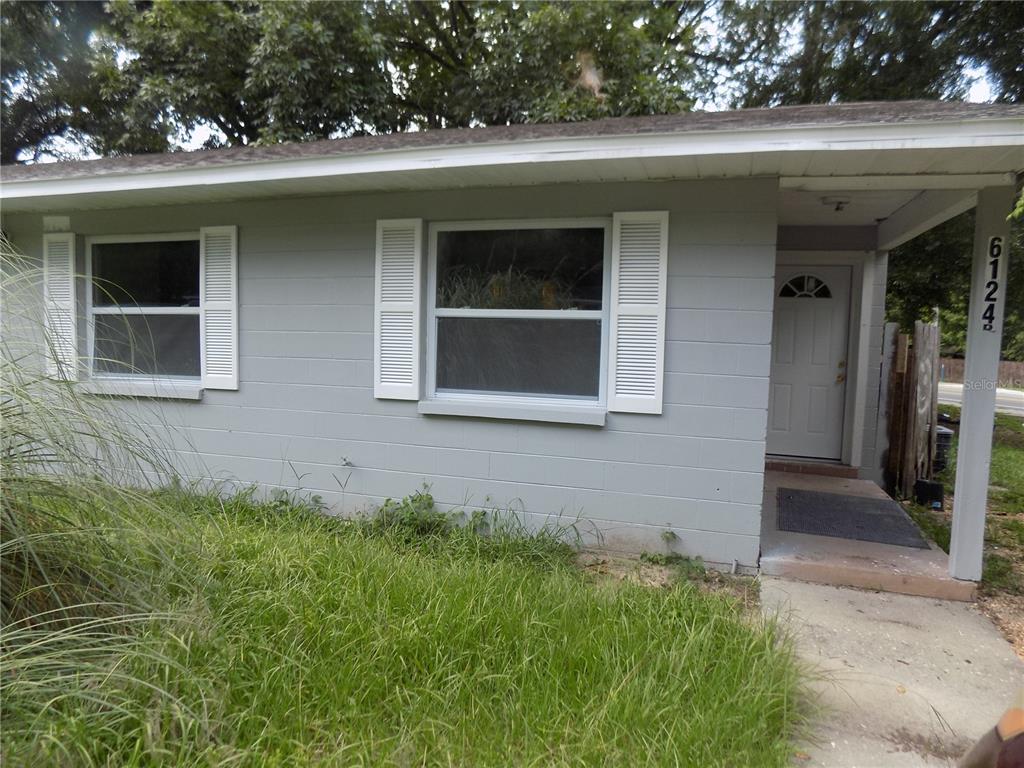 6124 Southwest 10th Place Gainesville, FL 32607 - Photo 1 of 6 a front view of a house with a yard