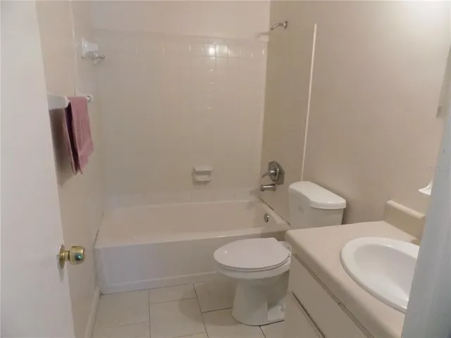 a white toilet sitting next to a bath tub