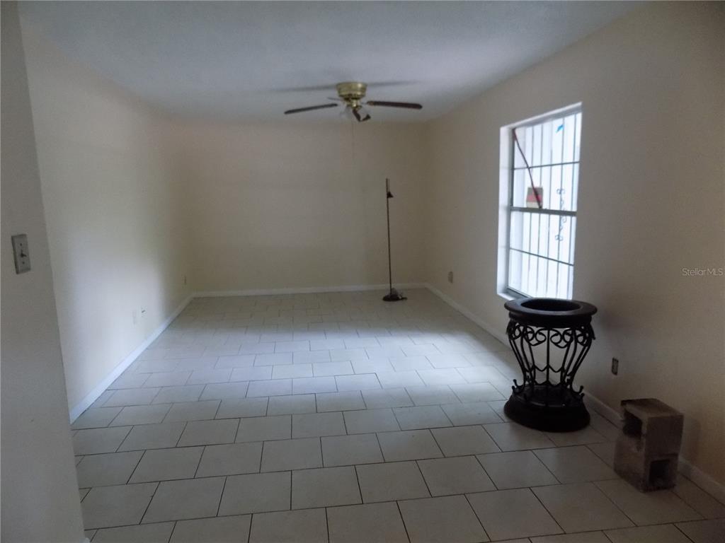 6124 Southwest 10th Place Gainesville, FL 32607 - Photo 6 of 6 an empty room with windows and chandelier