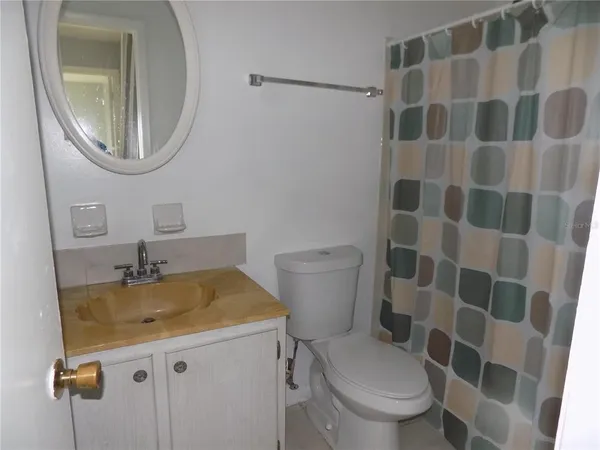 a bathroom with a sink toilet and a mirror