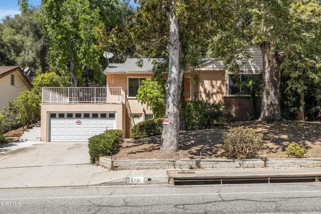 front view of a house with a tree