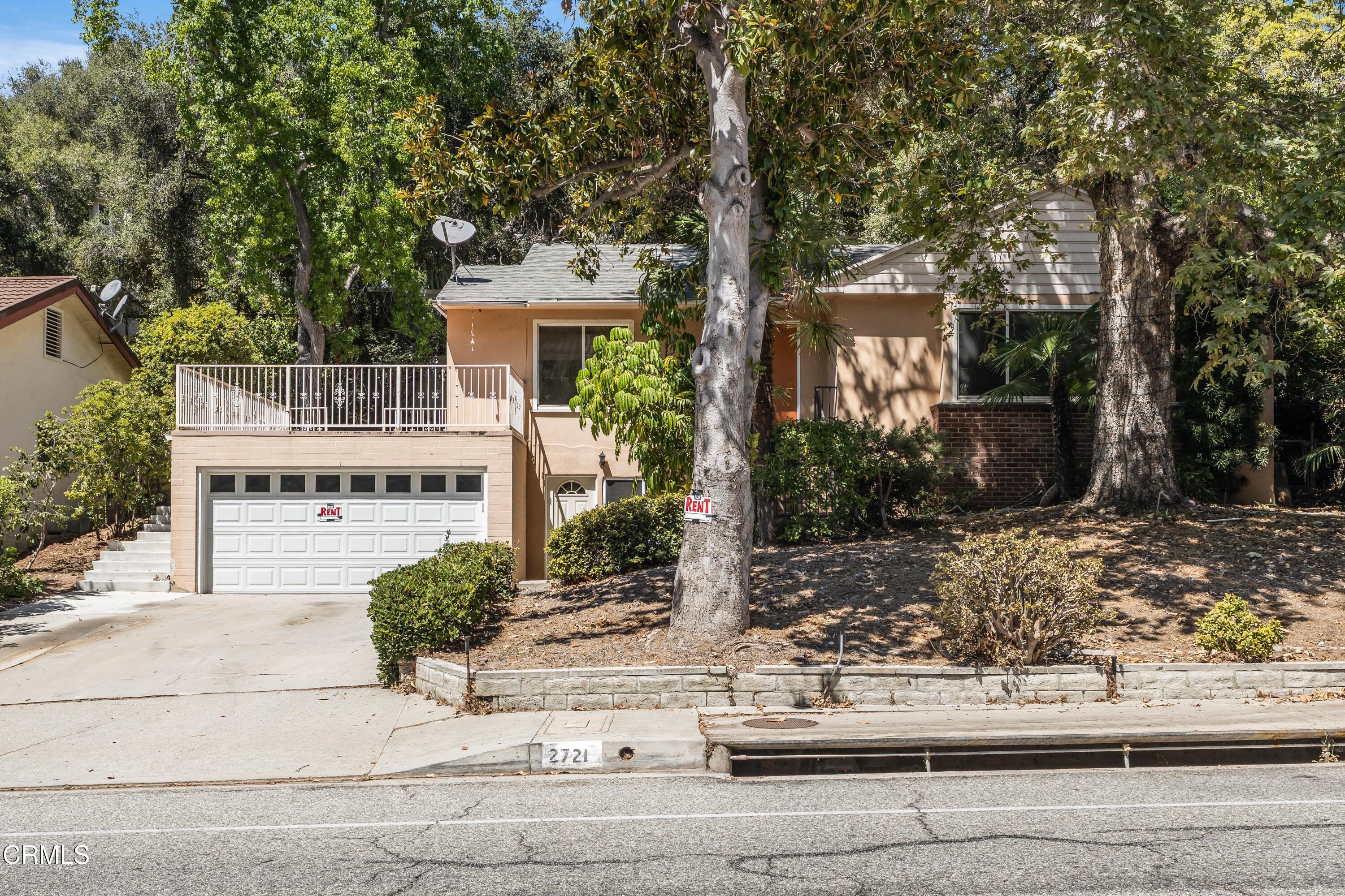 front view of a house with a tree