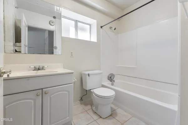a bathroom with a sink toilet vanity and shower