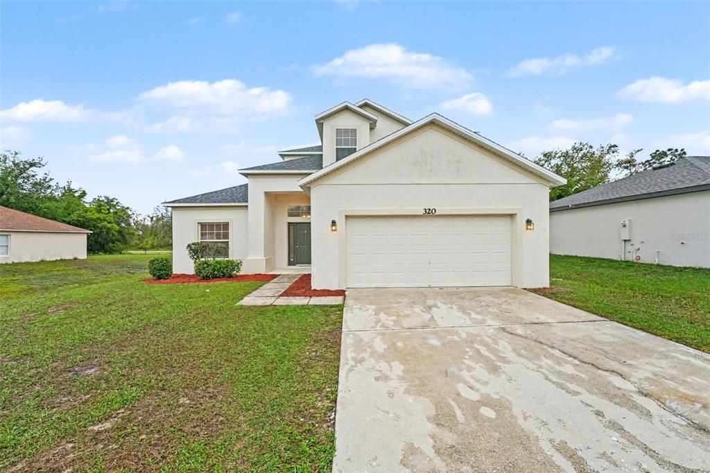320 Snook Way Kissimmee, FL 34759 - Photo 1 of 15 a view of a house with a yard and large tree