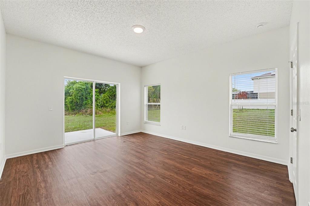 320 Snook Way Kissimmee, FL 34759 - Photo 14 of 15 an empty room with wooden floor and windows