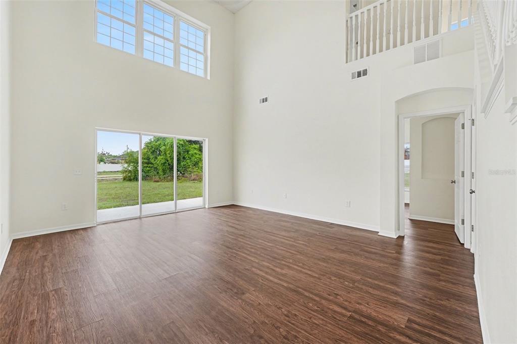 320 Snook Way Kissimmee, FL 34759 - Photo 2 of 15 a view of an empty room with wooden floor and a window