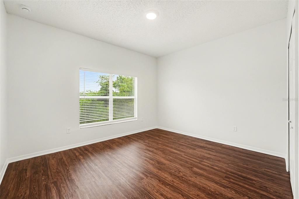 320 Snook Way Kissimmee, FL 34759 - Photo 7 of 15 a view of an empty room with wooden floor and a window