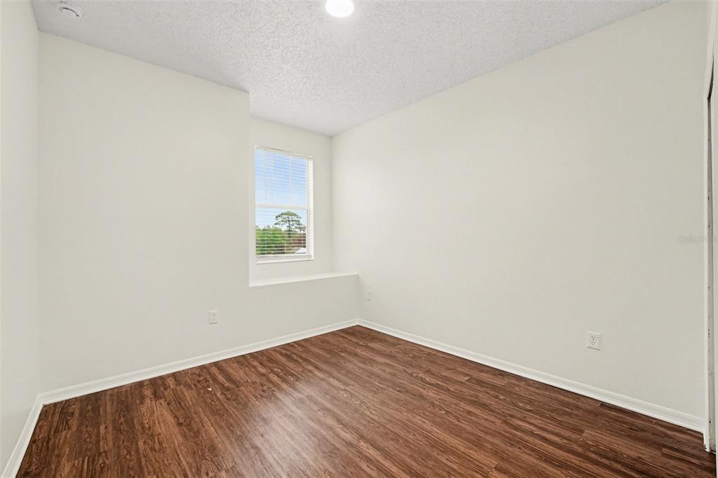 320 Snook Way Kissimmee, FL 34759 - Photo 9 of 15 a view of an empty room with wooden floor and a window