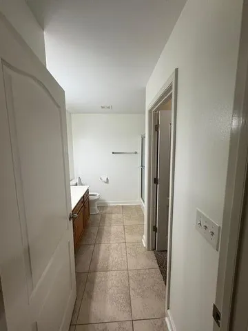 a bathroom with a glass shower door and a sink