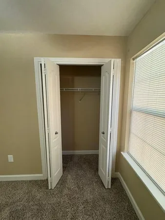 a view of an empty room with a ceiling fan