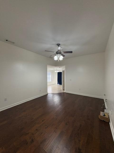 3157 Forrest Avenue Crestview, FL 32539 - Photo 2 of 22 an empty room with wooden floor chandelier fan and windows