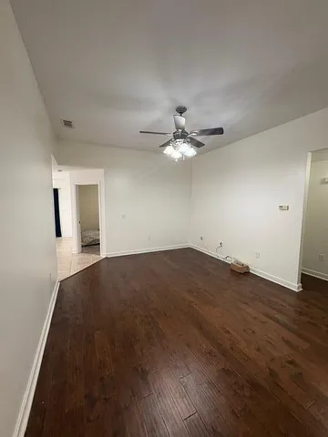 a view of a livingroom with wooden floor and a window