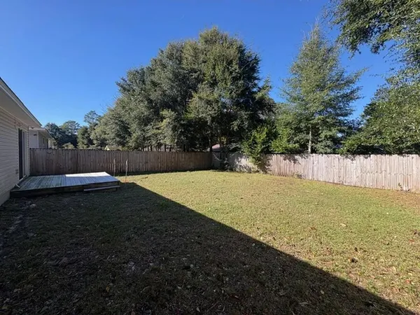 an aerial view of a house with a yard and lake view