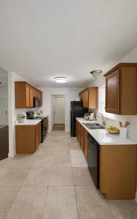 a kitchen with a sink counter top space appliances and cabinets