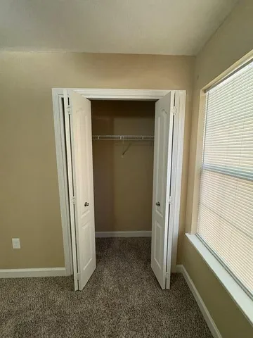 a view of an empty room with a ceiling fan