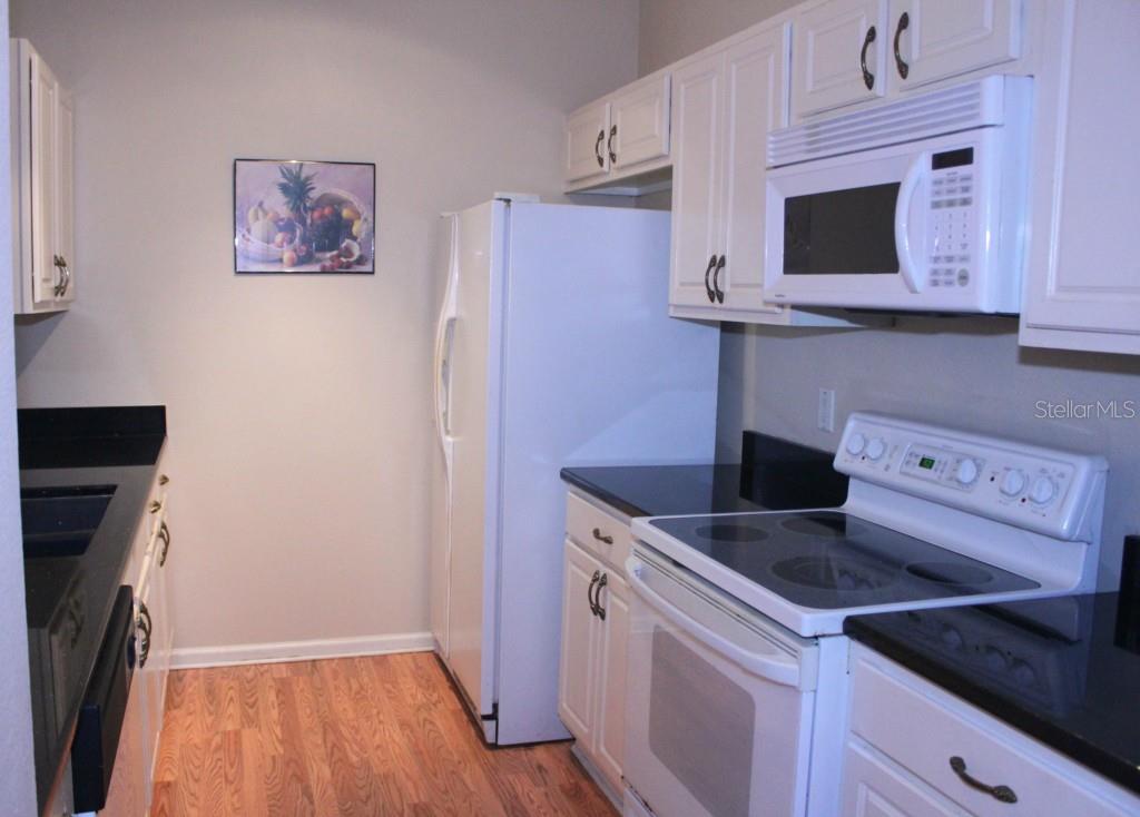 581 Brantley Terrace Way, Unit 203 Altamonte Springs, FL 32714 - Photo 1 of 1 a kitchen with stainless steel appliances granite countertop a sink and a microwave