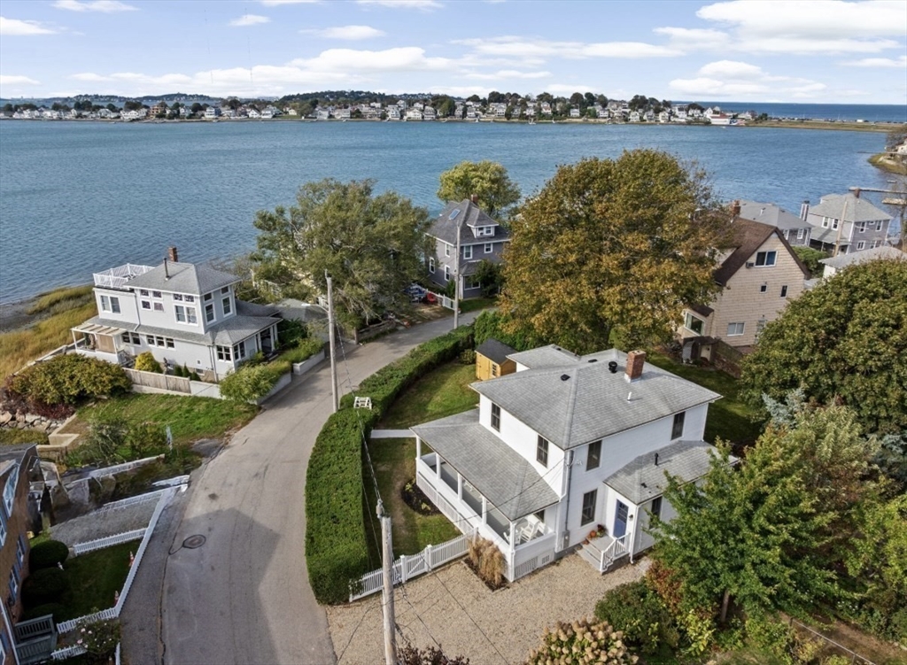 an aerial view of a house with outdoor space and lake view