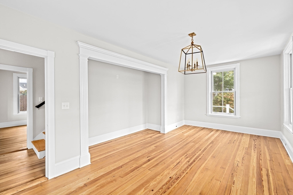 92 Hampton Circle Hull, MA 02045 - Photo 17 of 28 a view of empty room with wooden floor and windows