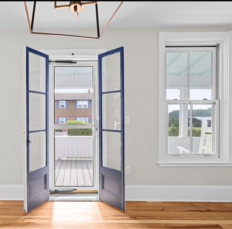 92 Hampton Circle Hull, MA 02045 - Photo 18 of 28 a view of an empty room with wooden floor and a window