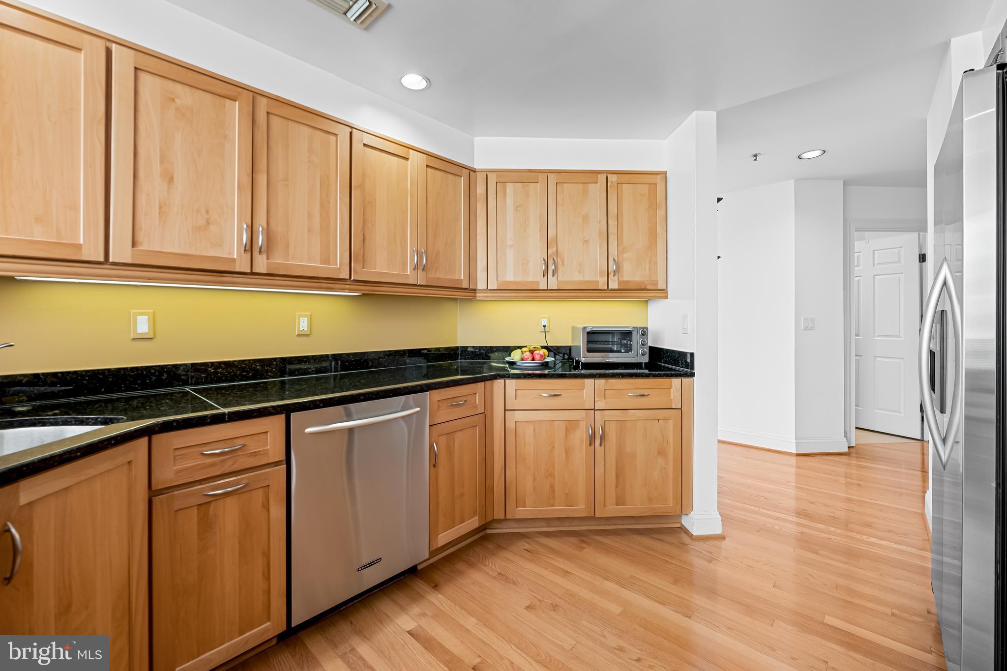 3704 North Charles Street, Unit 406 Baltimore, MD 21218 - Photo 14 of 65 a kitchen with granite countertop cabinets stainless steel appliances and a window