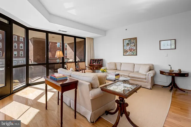 a view of bathroom with a sink mirror toilet and next to a window