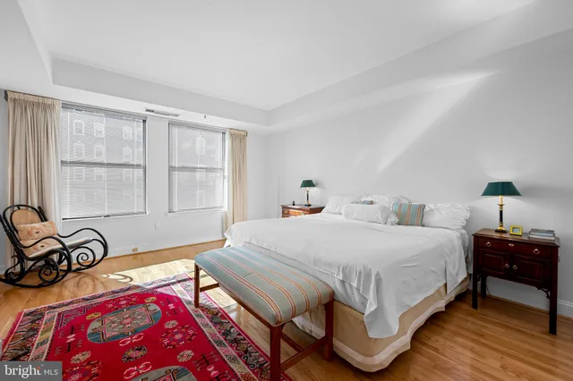 a living room with furniture rug and wooden floor