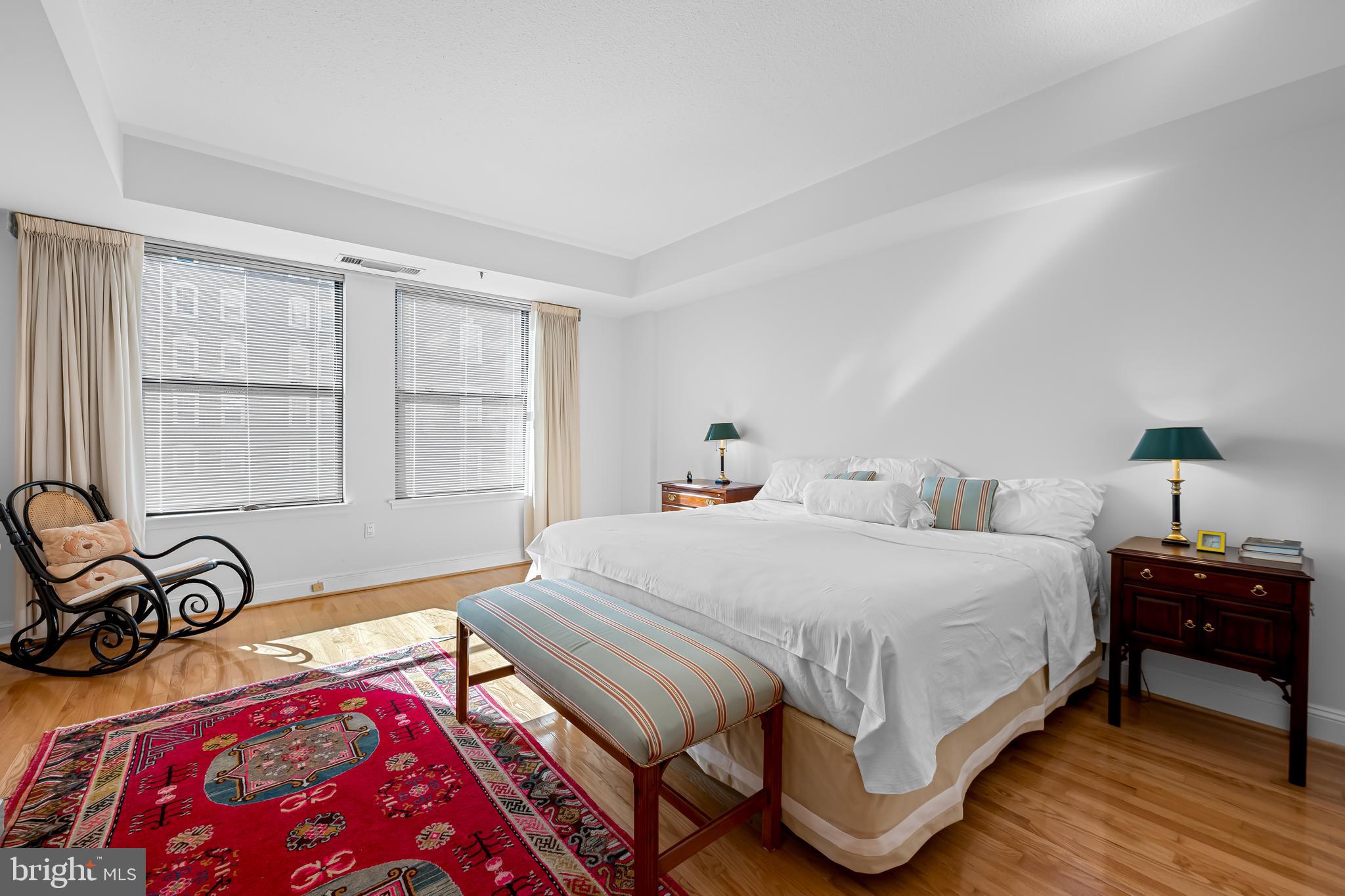 3704 North Charles Street, Unit 406 Baltimore, MD 21218 - Photo 20 of 65 a bedroom with a bed and wooden floor