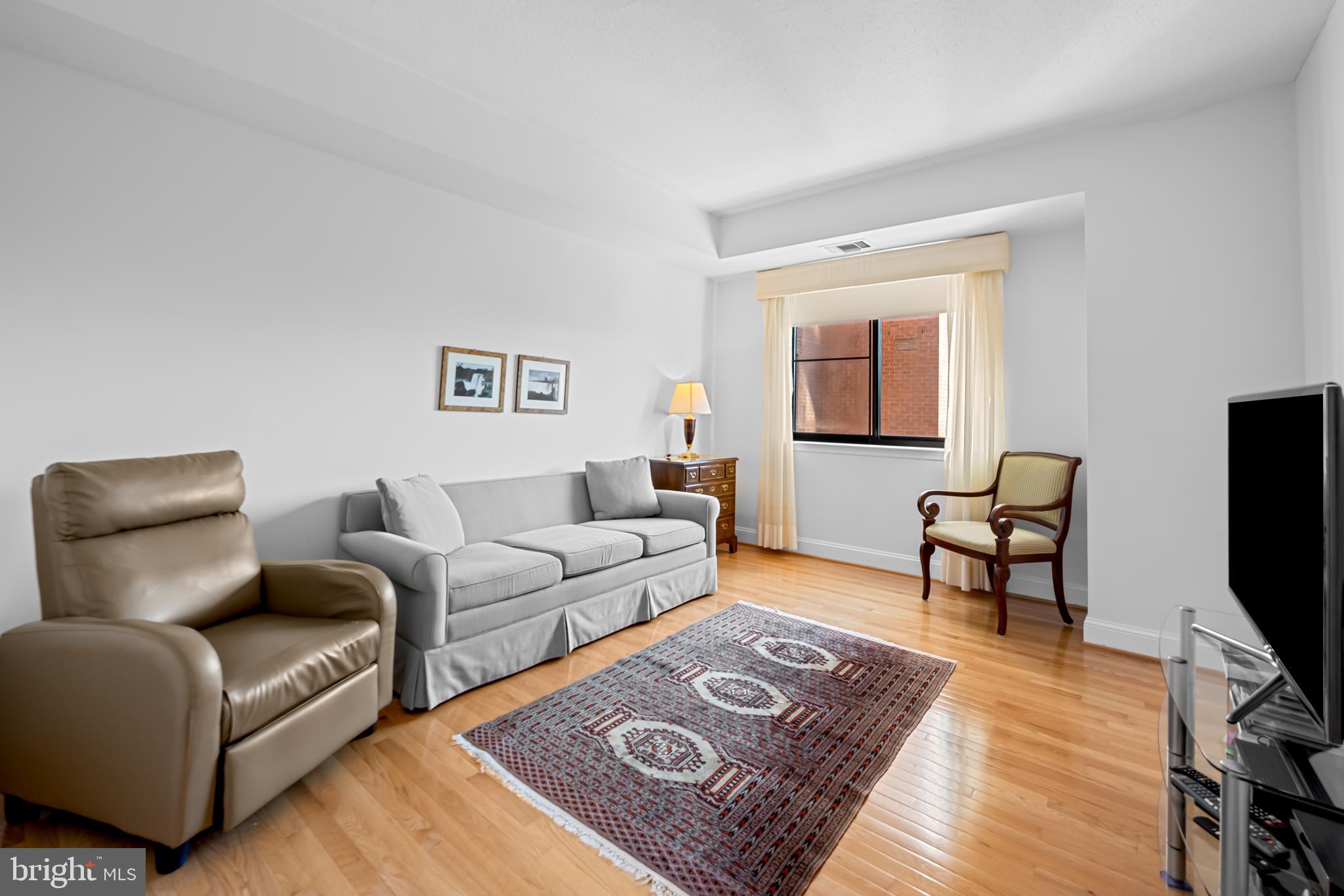 3704 North Charles Street, Unit 406 Baltimore, MD 21218 - Photo 27 of 65 a living room with furniture rug and wooden floor