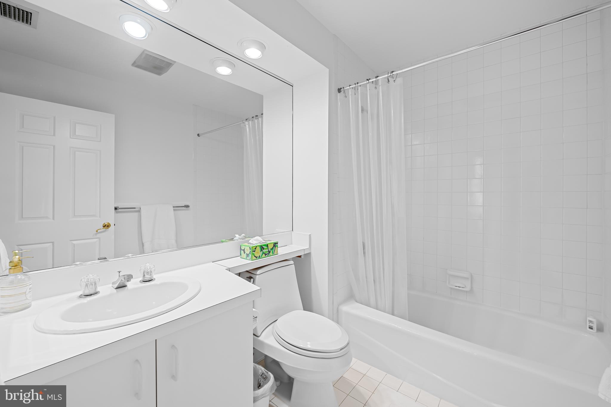 3704 North Charles Street, Unit 406 Baltimore, MD 21218 - Photo 28 of 65 a bathroom with a sink toilet and shower