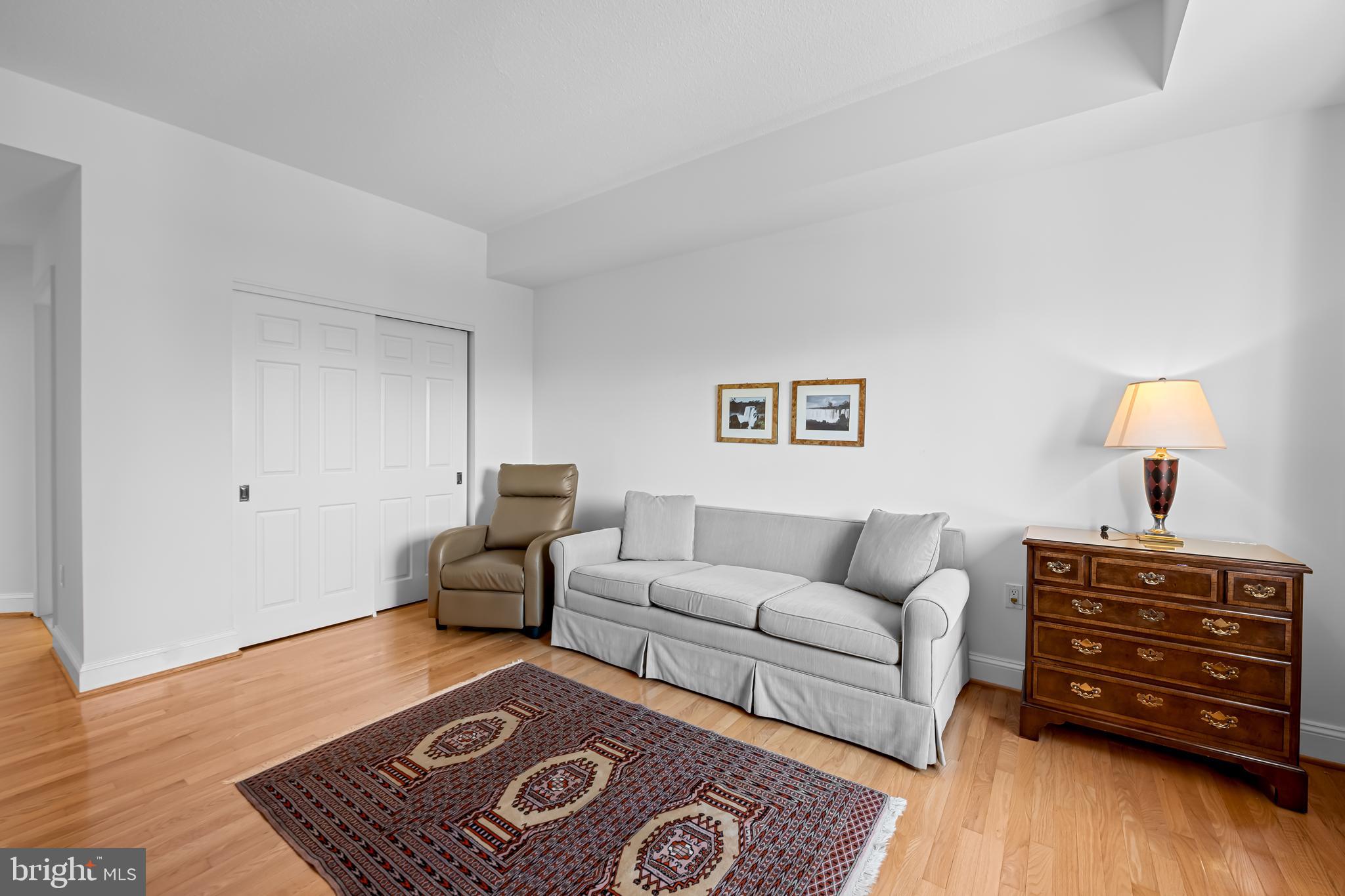 3704 North Charles Street, Unit 406 Baltimore, MD 21218 - Photo 29 of 65 a living room with furniture and wooden floor