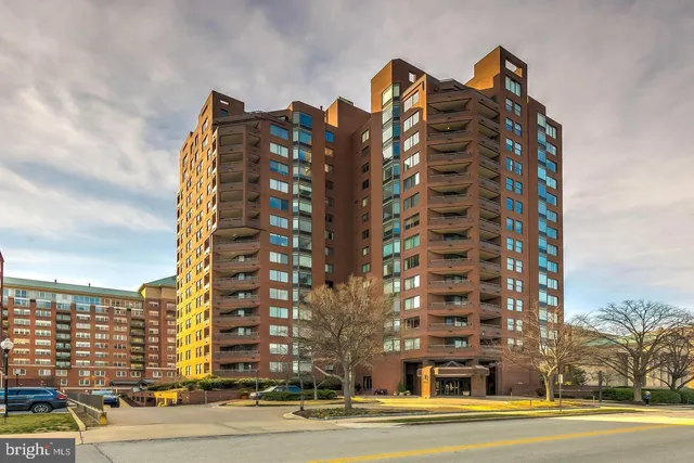 a view of a hallway with furniture and windows