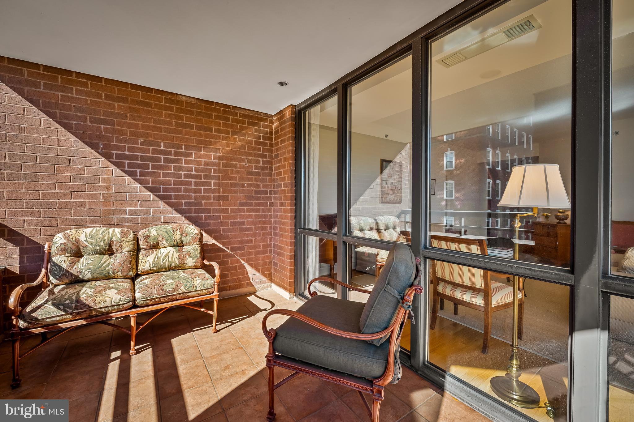3704 North Charles Street, Unit 406 Baltimore, MD 21218 - Photo 43 of 65 a view of a chairs and table in balcony