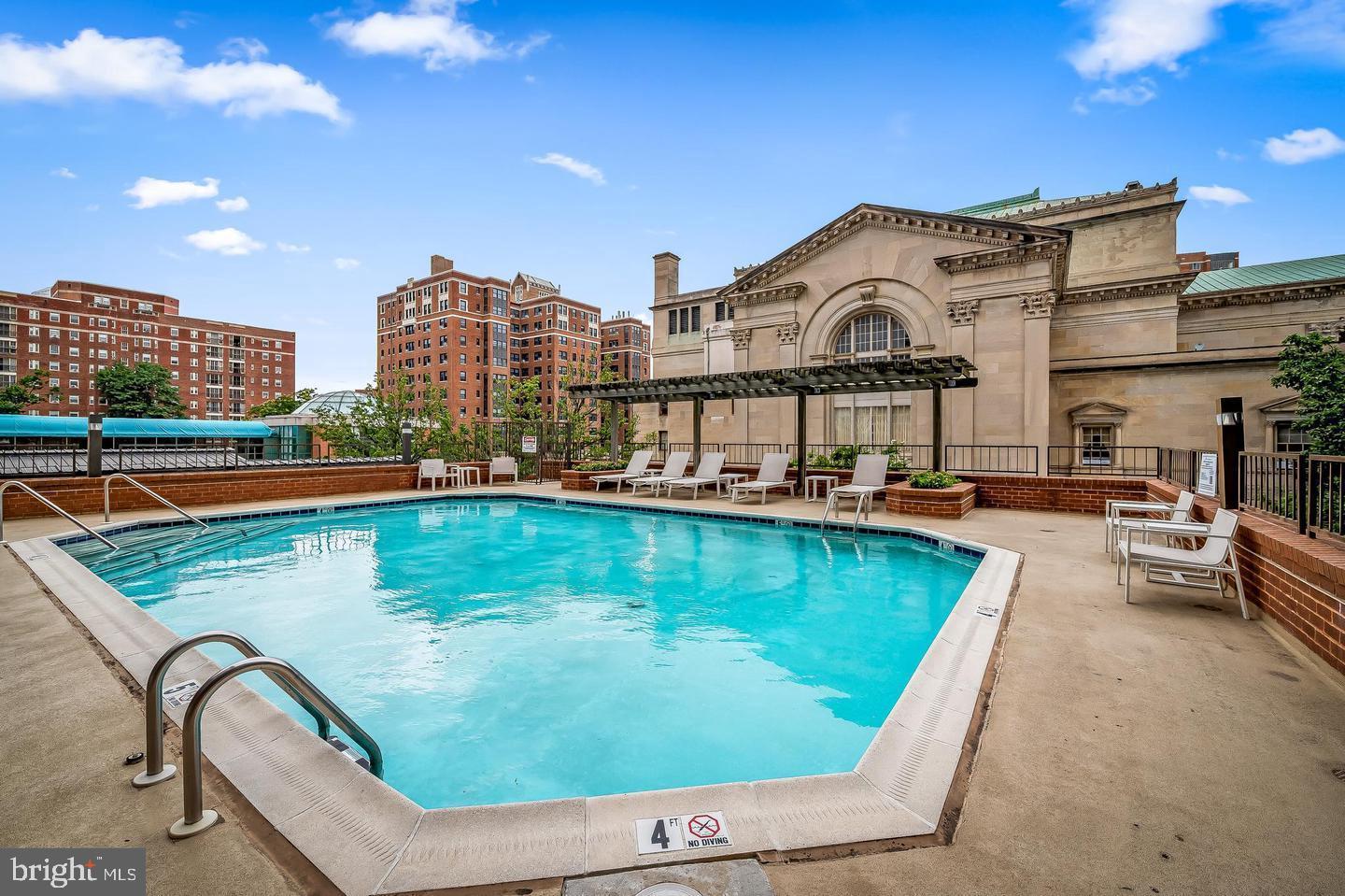 3704 North Charles Street, Unit 406 Baltimore, MD 21218 - Photo 49 of 65 a view of a swimming pool with a lounge chairs