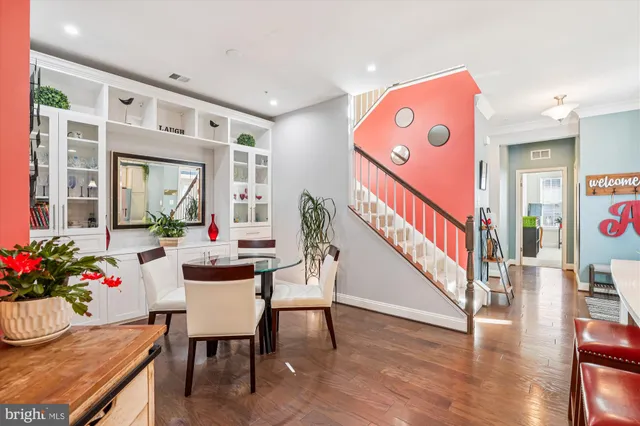 a view of a dining room with furniture and wooden floor