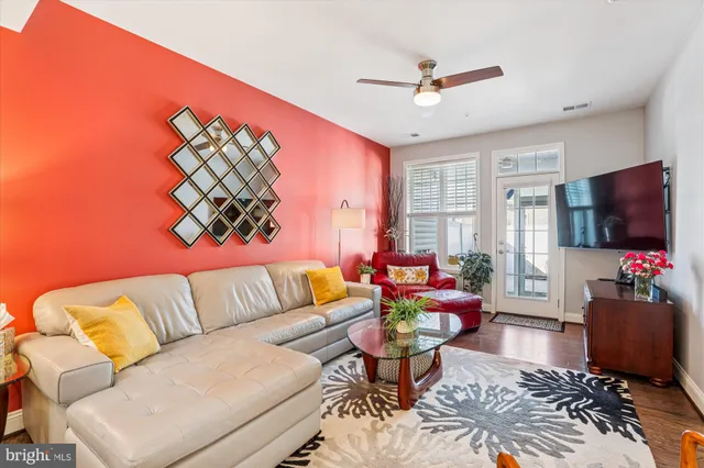 a living room with furniture ceiling fan and a rug