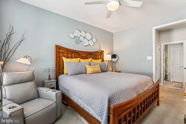 a bedroom with bed and a chandelier