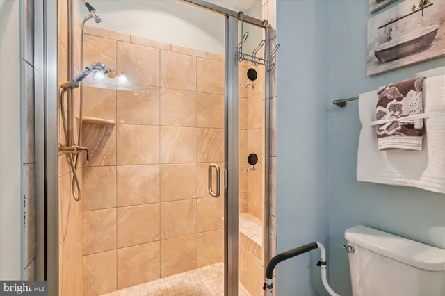a bathroom with a toilet and a shower