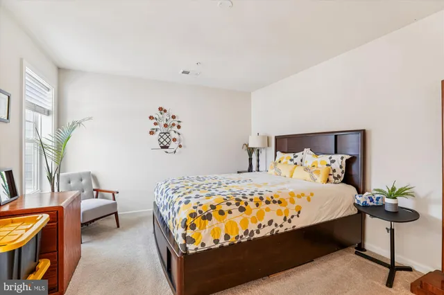 a bedroom with a bed and a potted plant