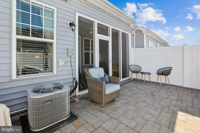 a view of a patio with dining table and chairs