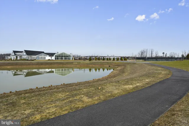 a view of a swimming pool with a patio and a yard
