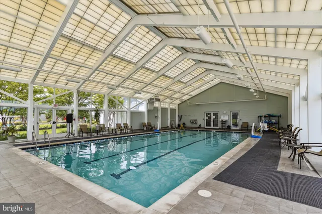a swimming pool with outdoor seating and city view