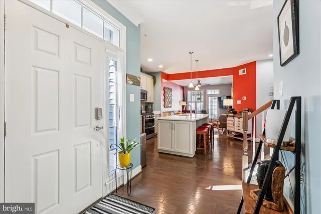 a very nice looking open dining room with kitchen island