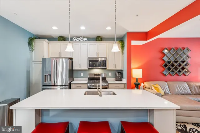 a large kitchen with a table chairs and a refrigerator