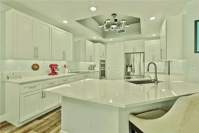 a kitchen with a sink appliances and cabinets