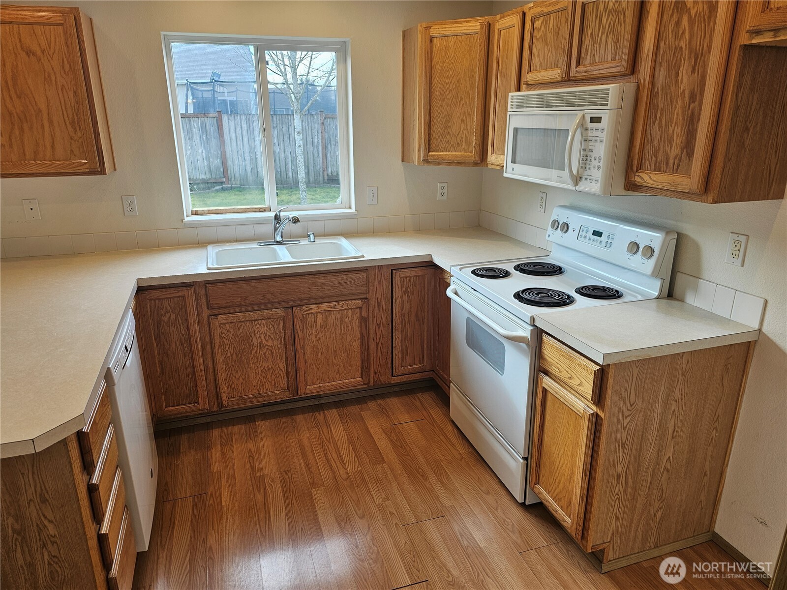 9814 Greenleaf Loop Southeast Yelm, WA 98597 - Photo 11 of 33 a kitchen with a stove sink and cabinets