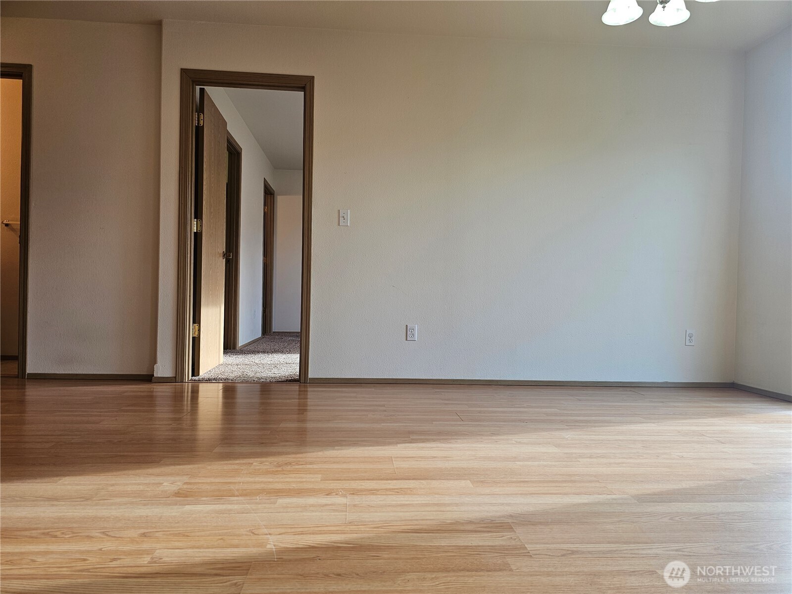 9814 Greenleaf Loop Southeast Yelm, WA 98597 - Photo 13 of 33 a view of an empty room with wooden floor and a window