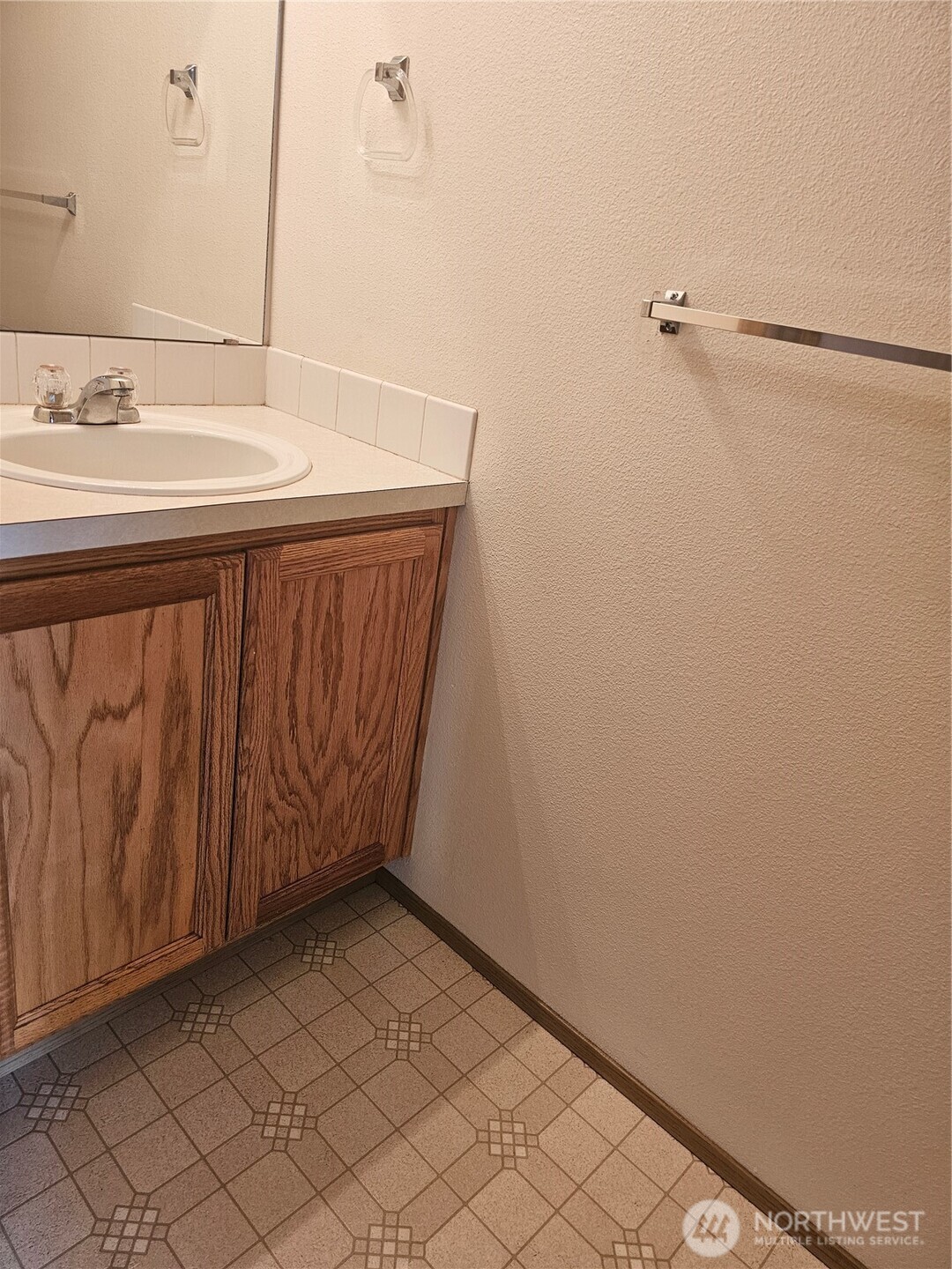 9814 Greenleaf Loop Southeast Yelm, WA 98597 - Photo 18 of 33 a bathroom with a sink and a mirror