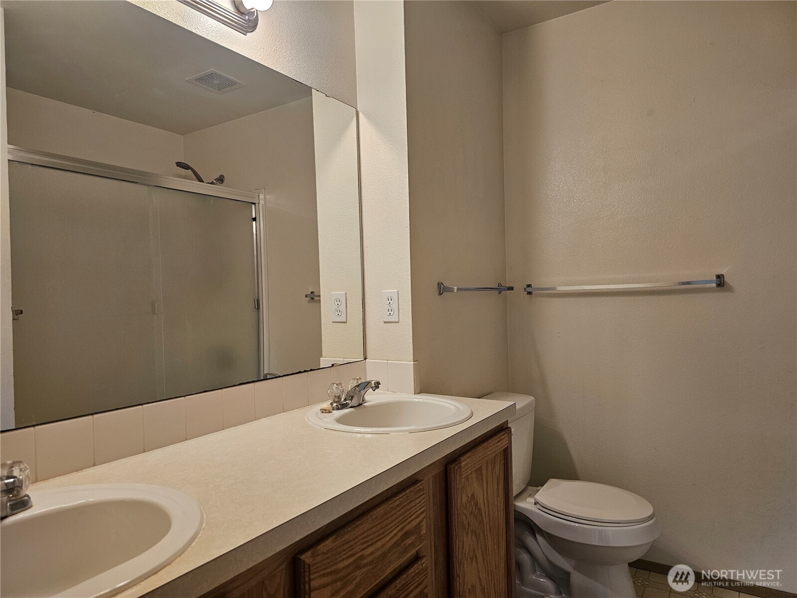 9814 Greenleaf Loop Southeast Yelm, WA 98597 - Photo 19 of 33 a bathroom with a sink toilet and a mirror